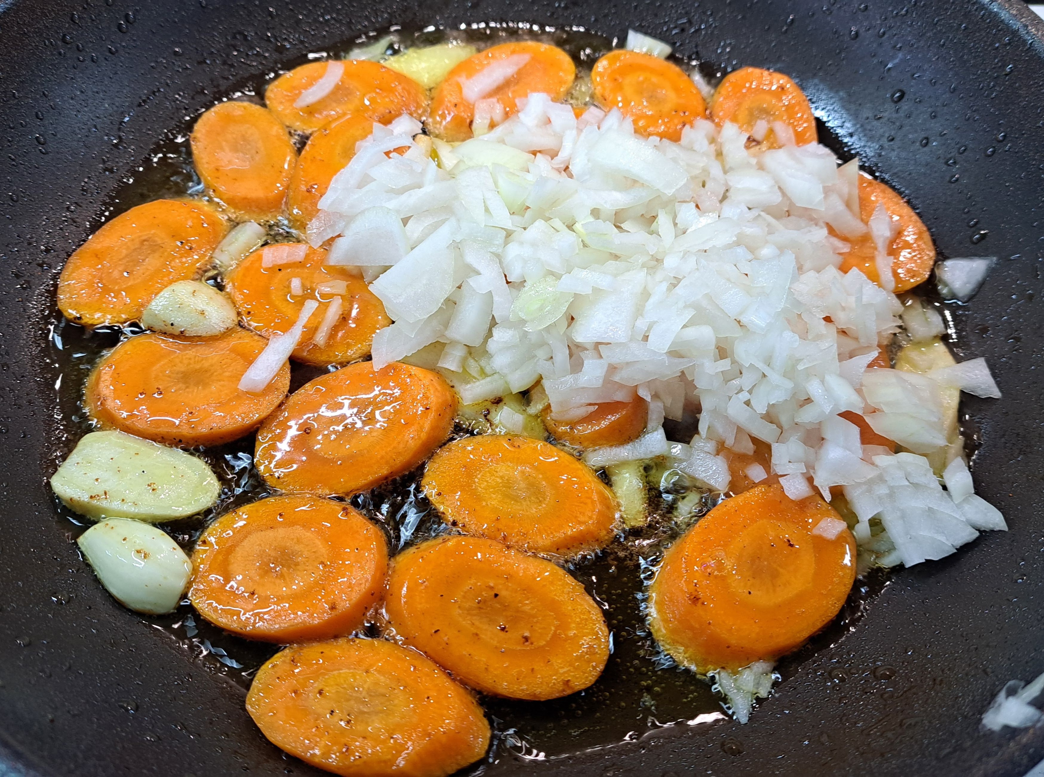 Po chvíli pridáme nakrájanú cibuľu a všetko spolu restujeme