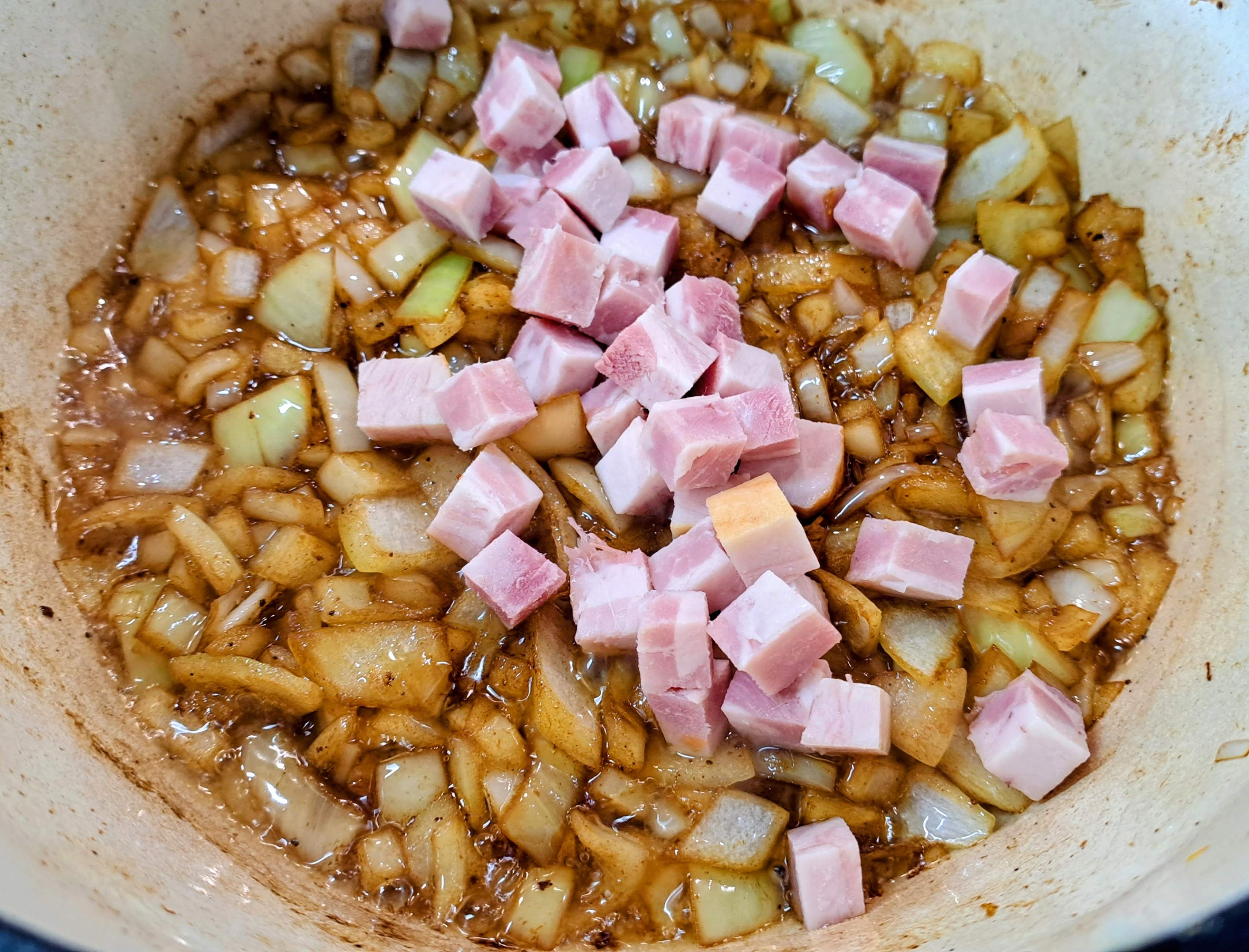 Pridáme na kocky nakrájané kúsky slaniny a zarestuujeme spolu s cibuľou